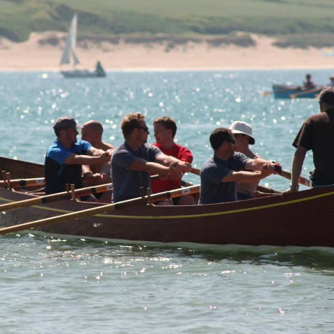 Members rowing at sea